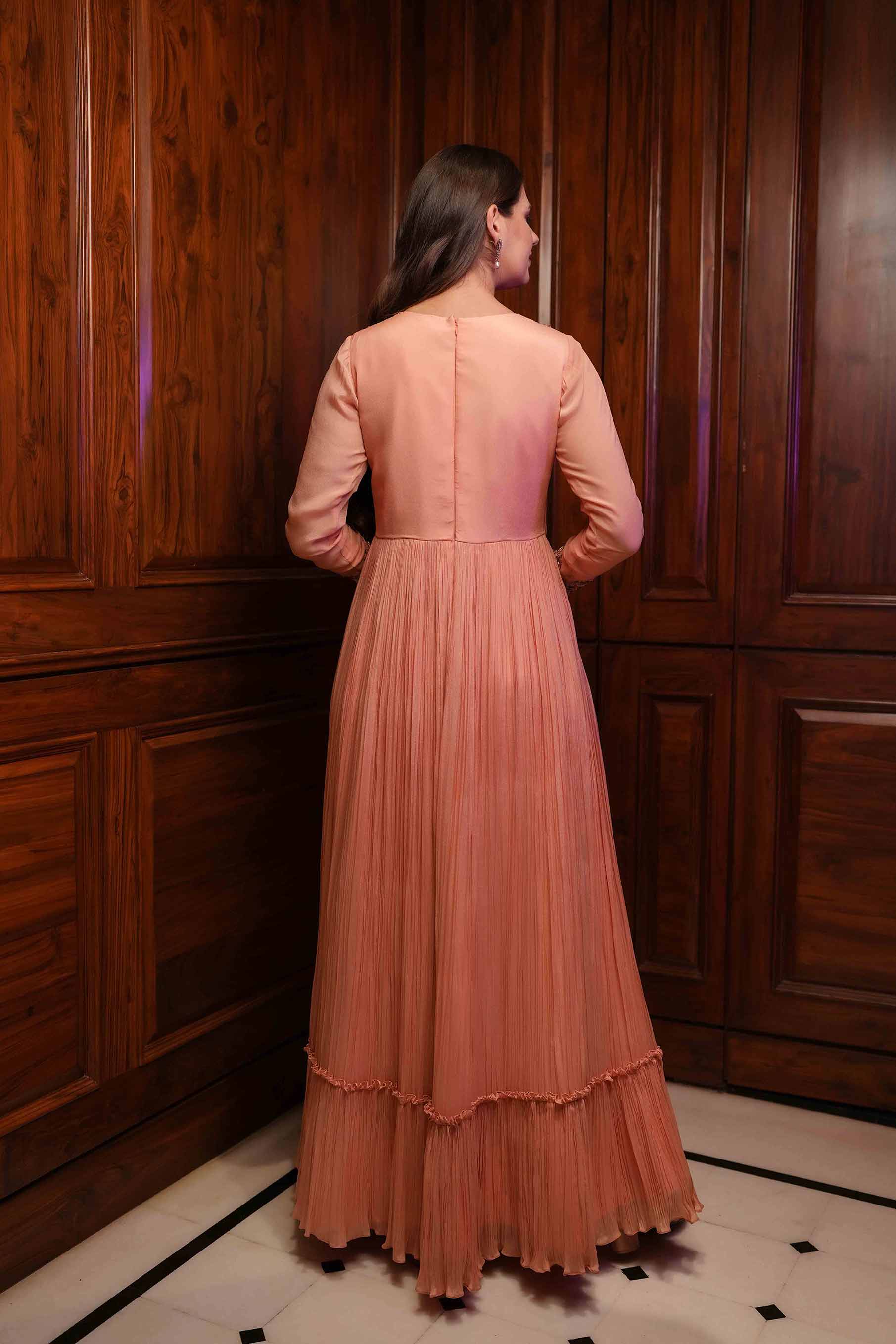 Peach gathered full sleeves gown.