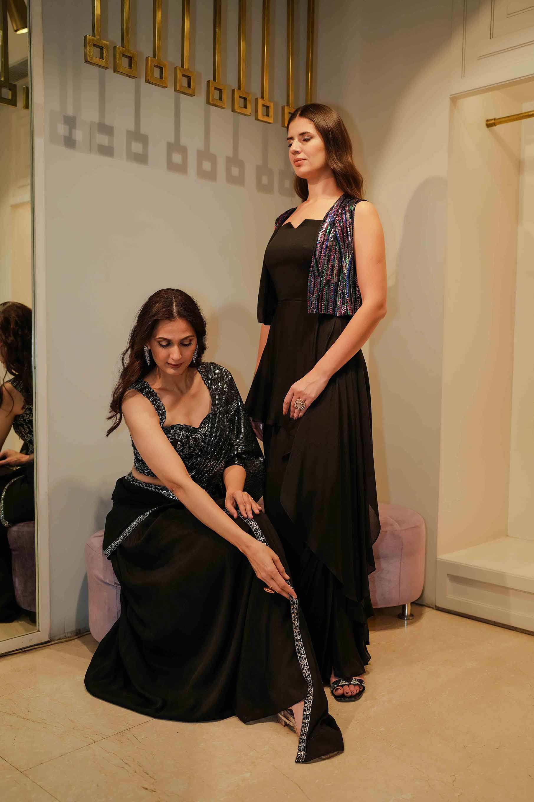 Black peplum style draped gown with jacket.