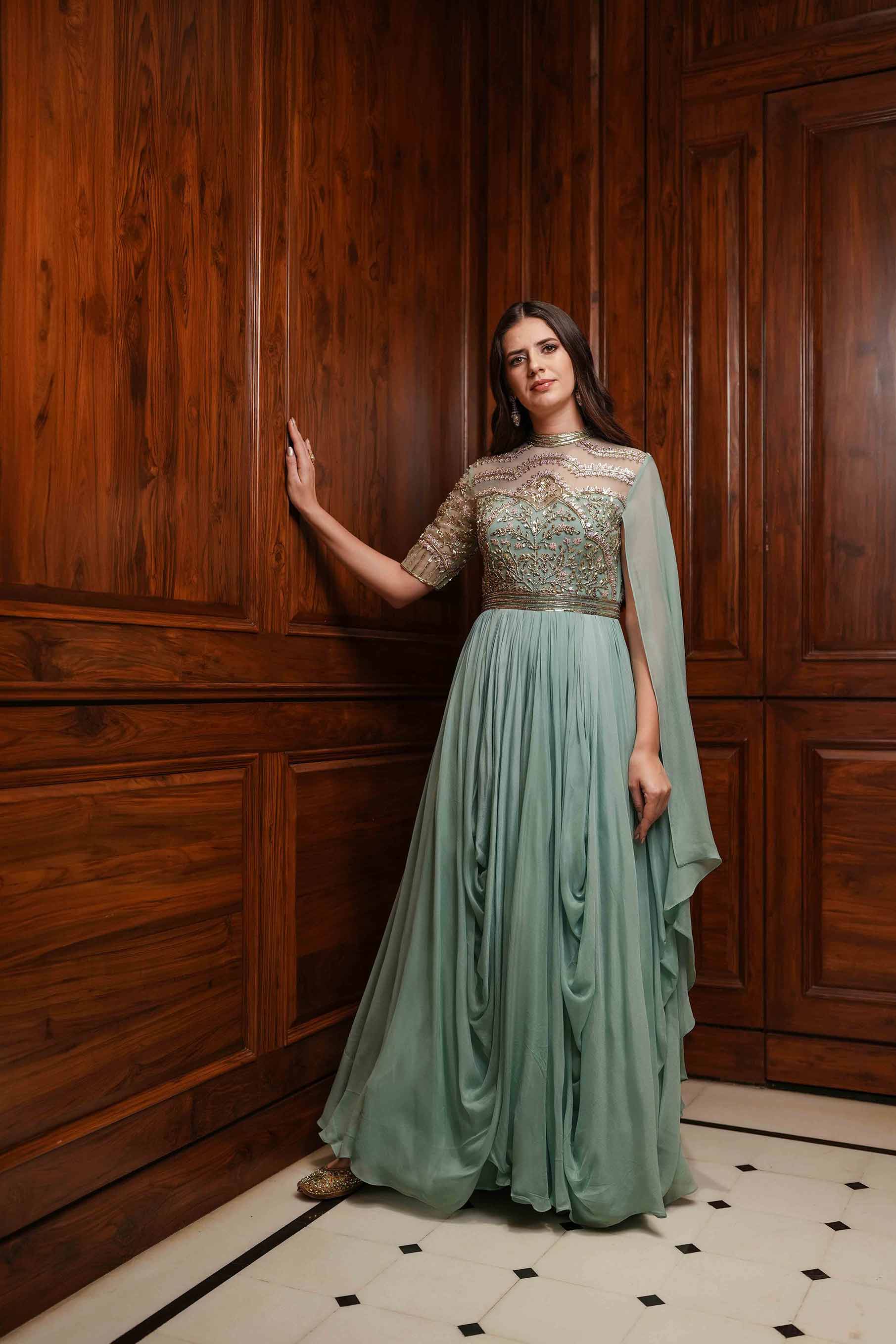 Dusty mint high neck embroidered cowl draped gown.