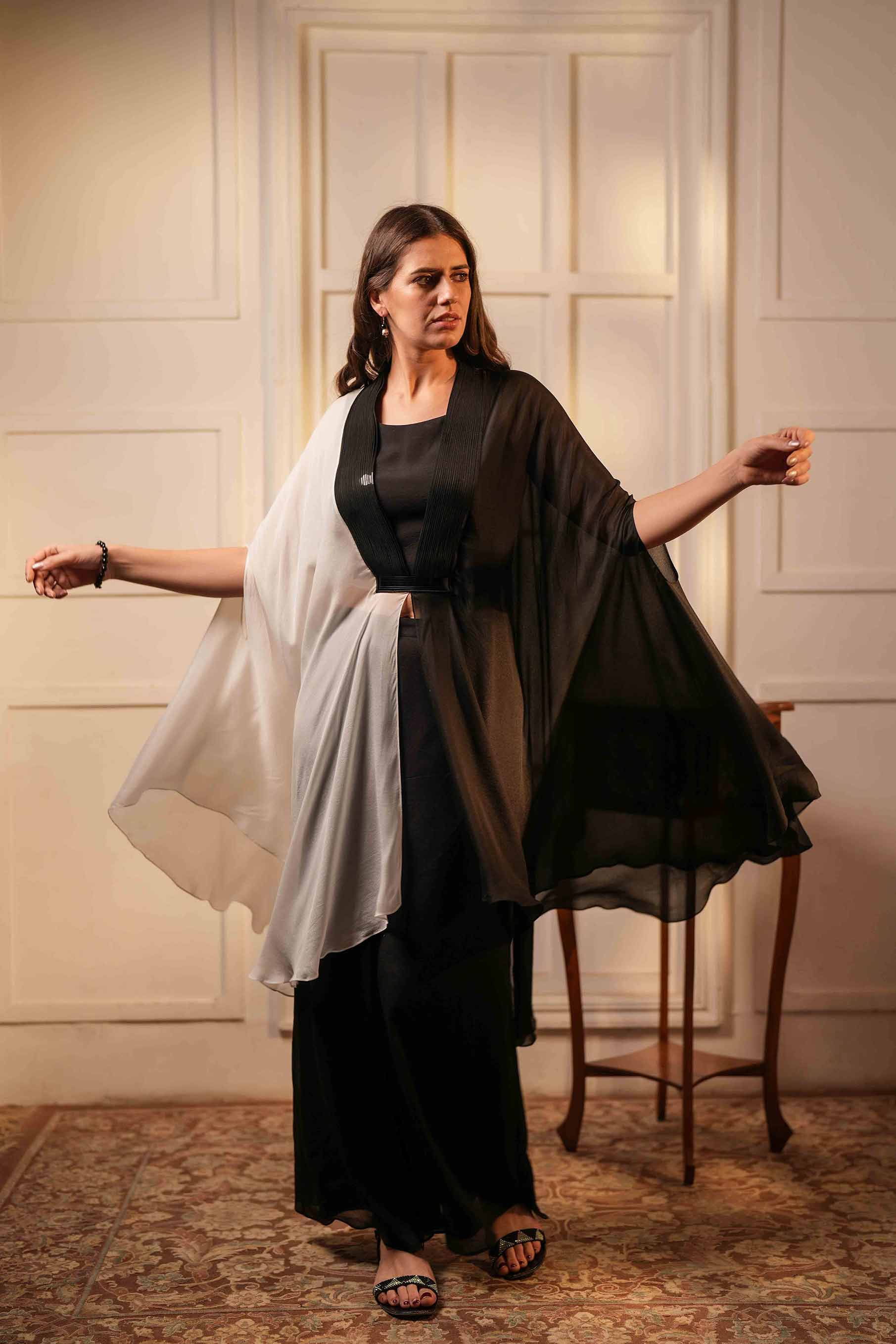 Black crop top with flared palazzo and asymmetric hem poncho style tunic.