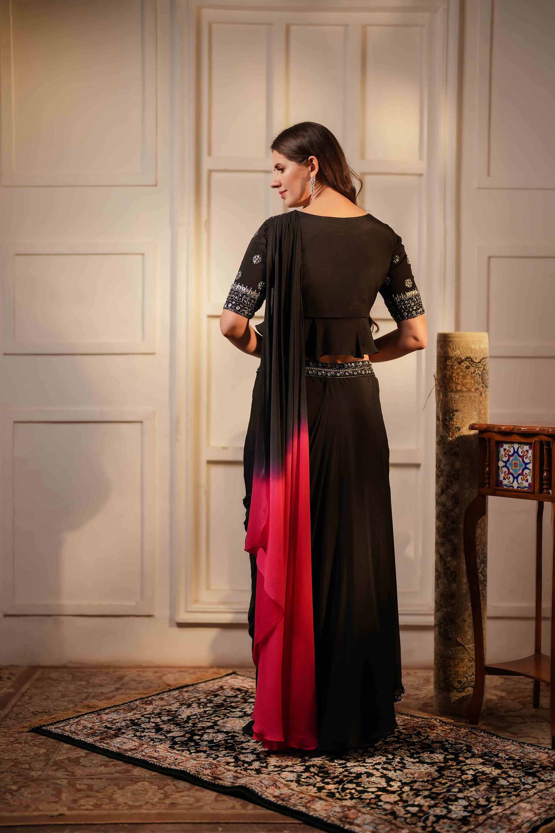 Black crepe ruffled blouse with draped skirt set.