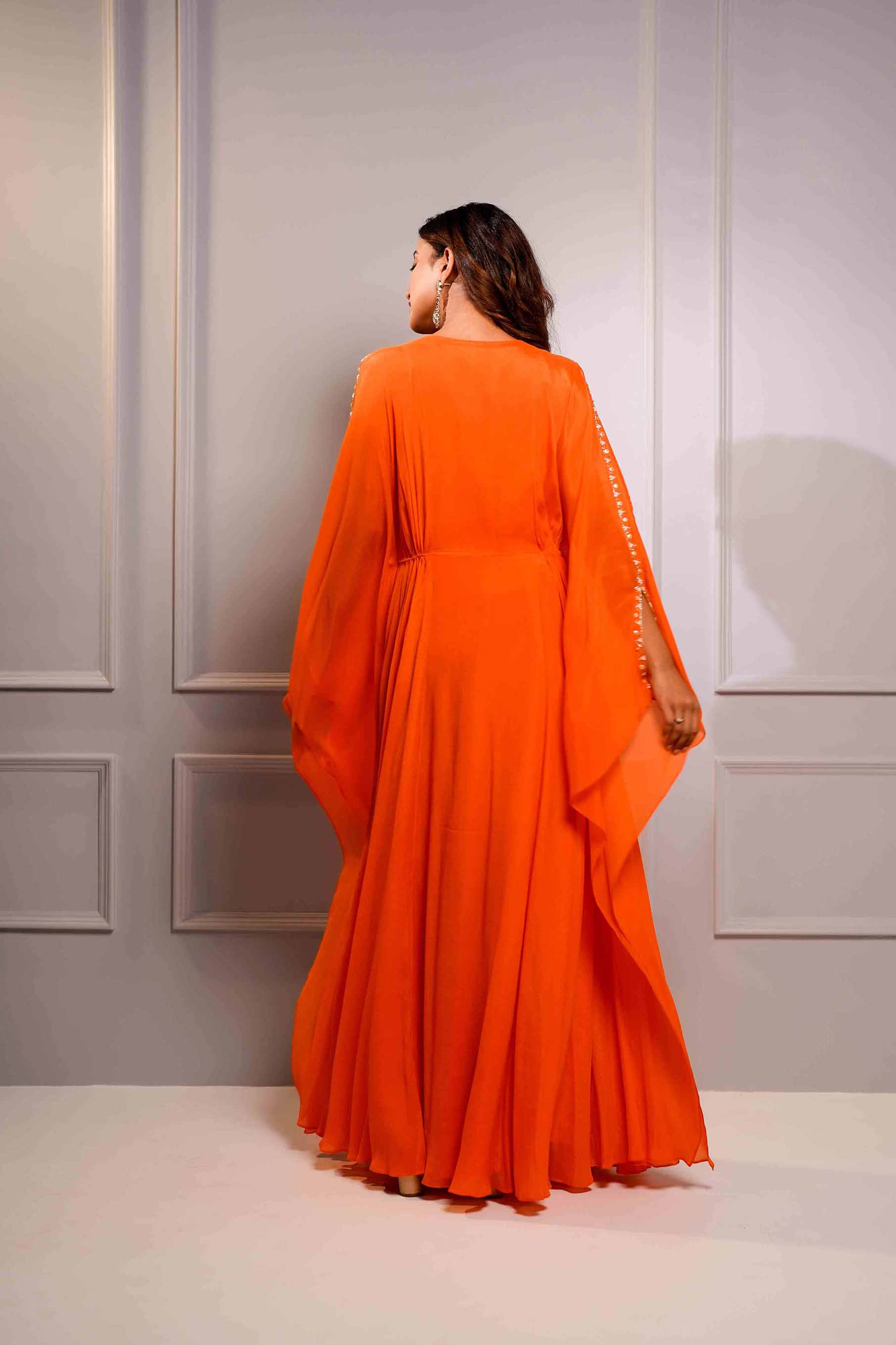 Orange crepe kaftan style gown.