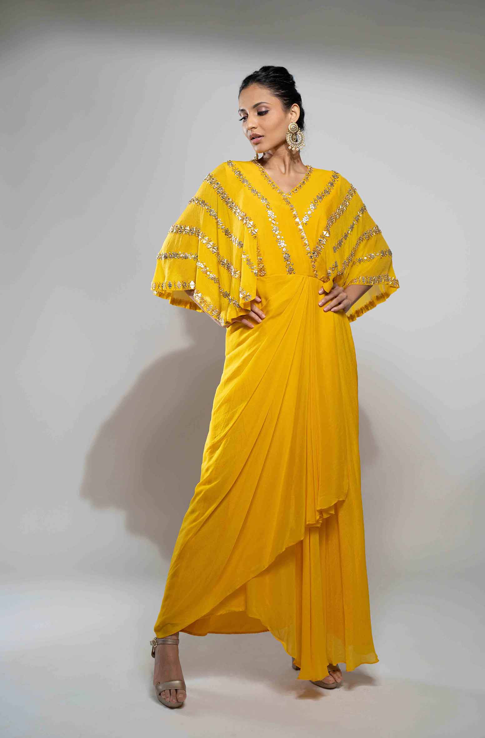 Mustard crepe draped gown.