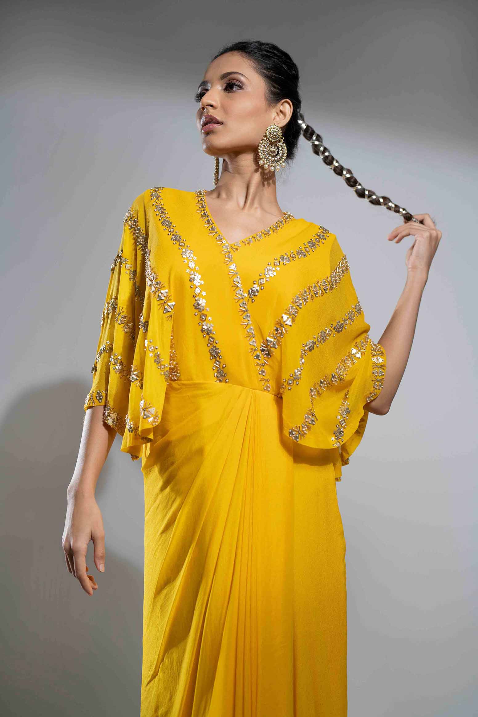 Mustard crepe draped gown.