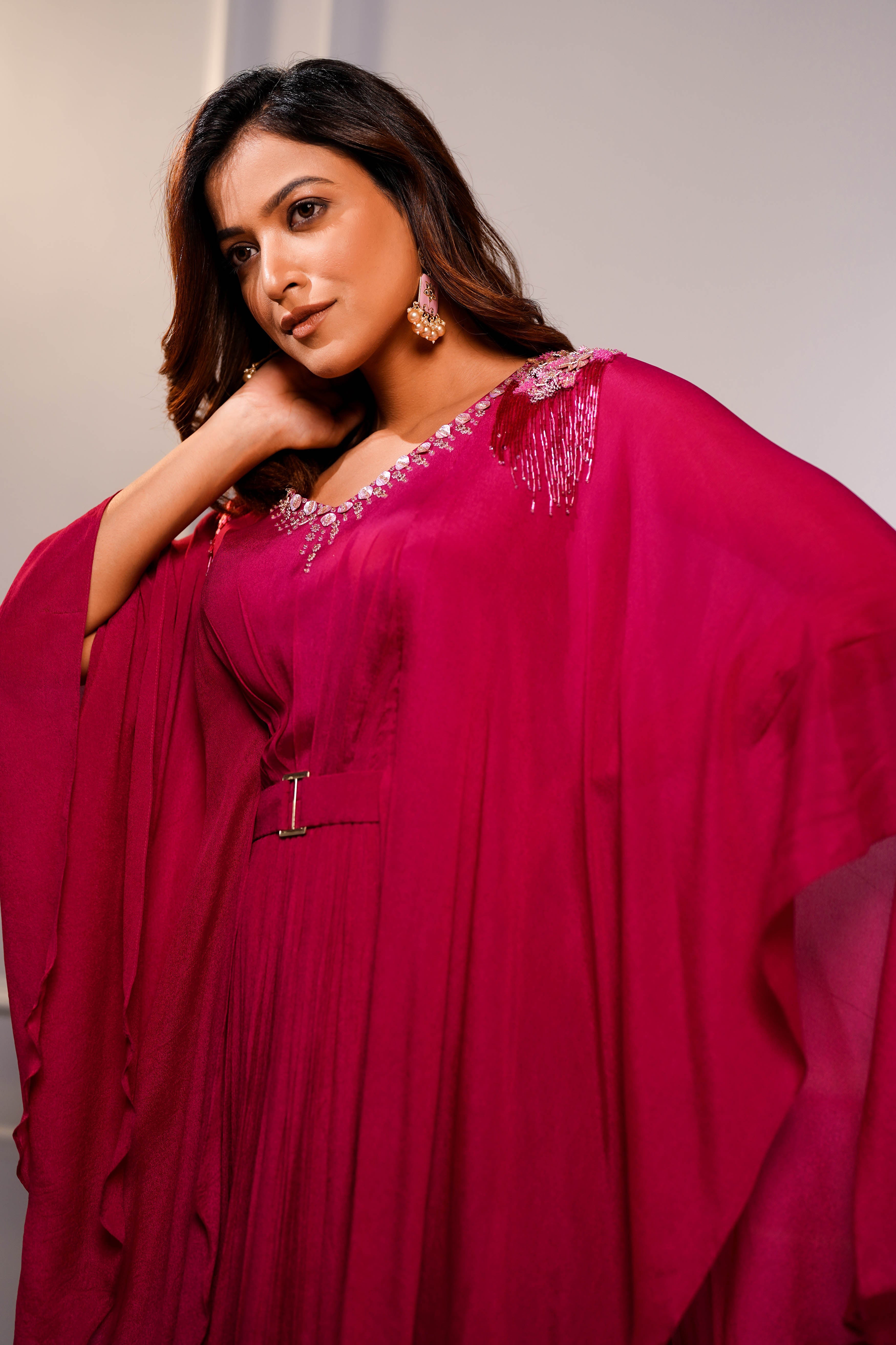 Magenta cape style gown.