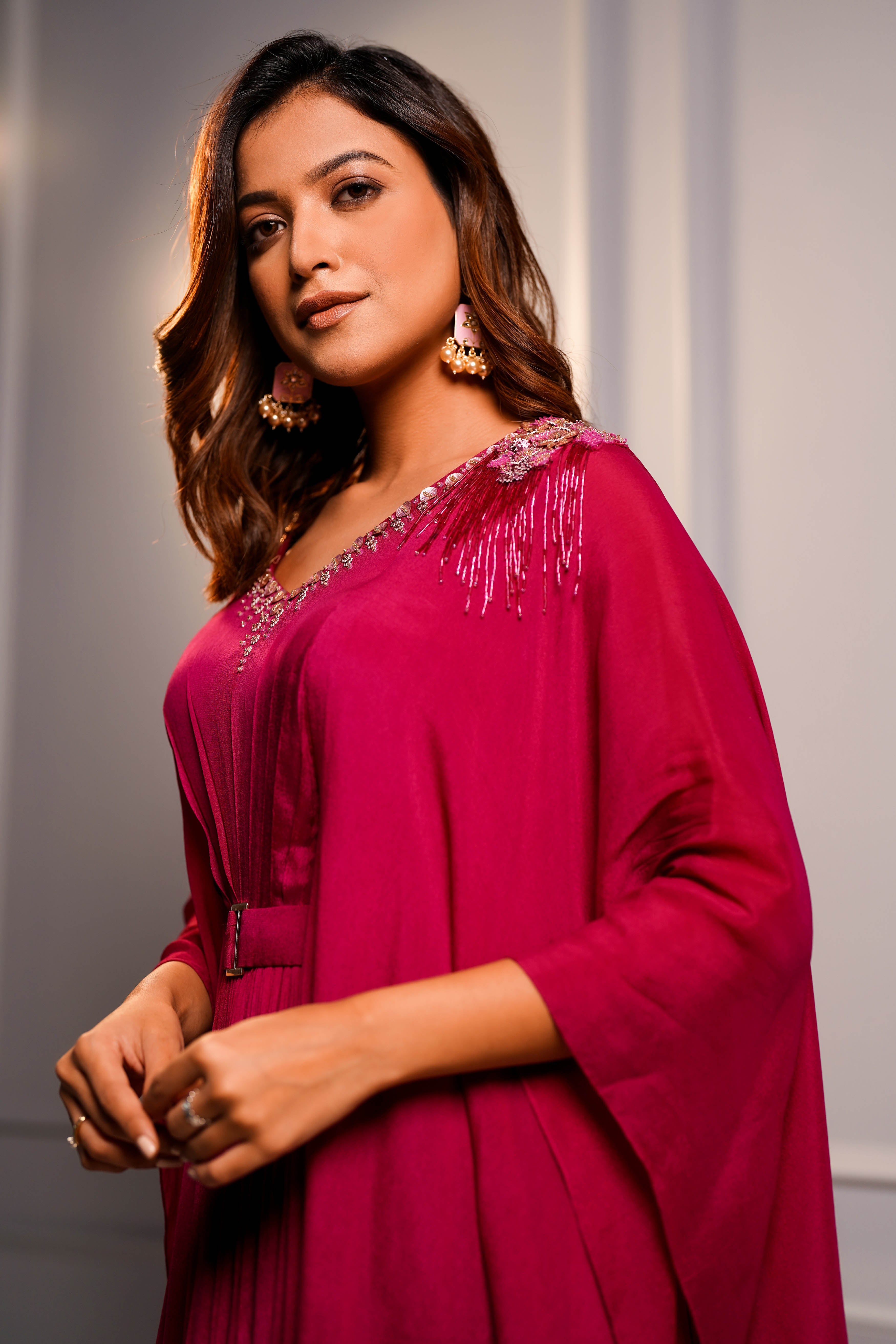 Magenta cape style gown.