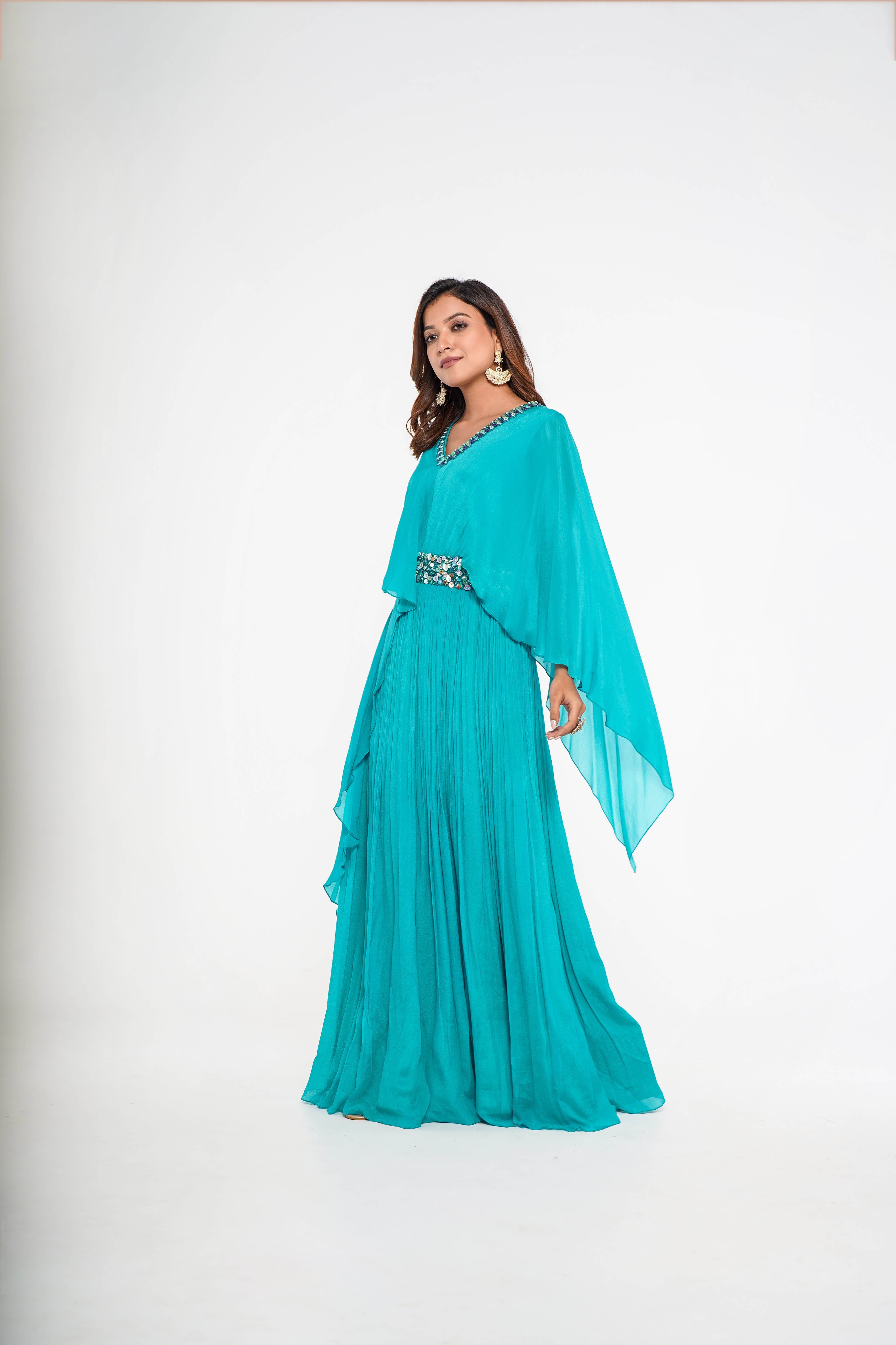 Sea green cape style draped gown.