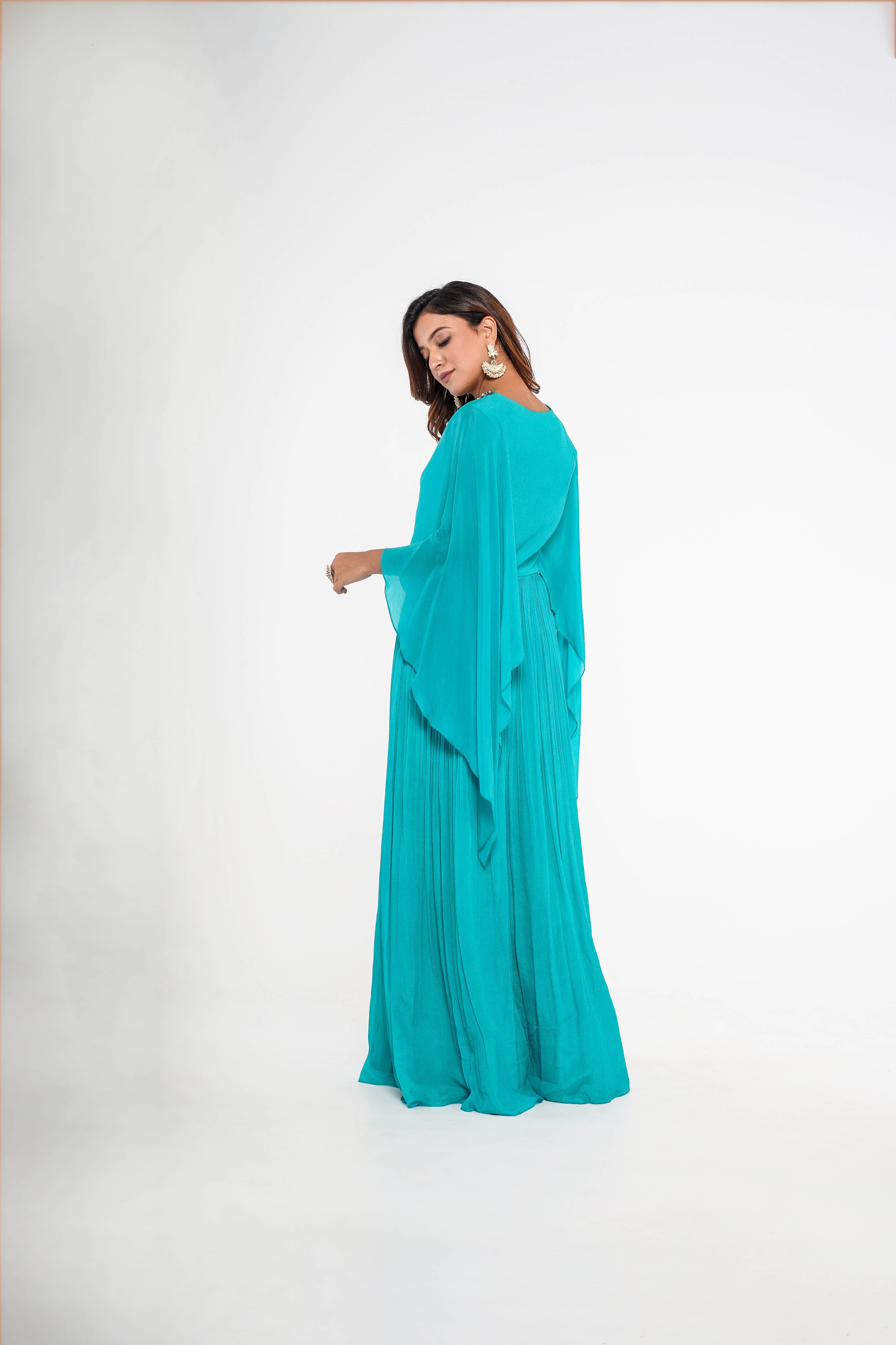 Sea green cape style draped gown.