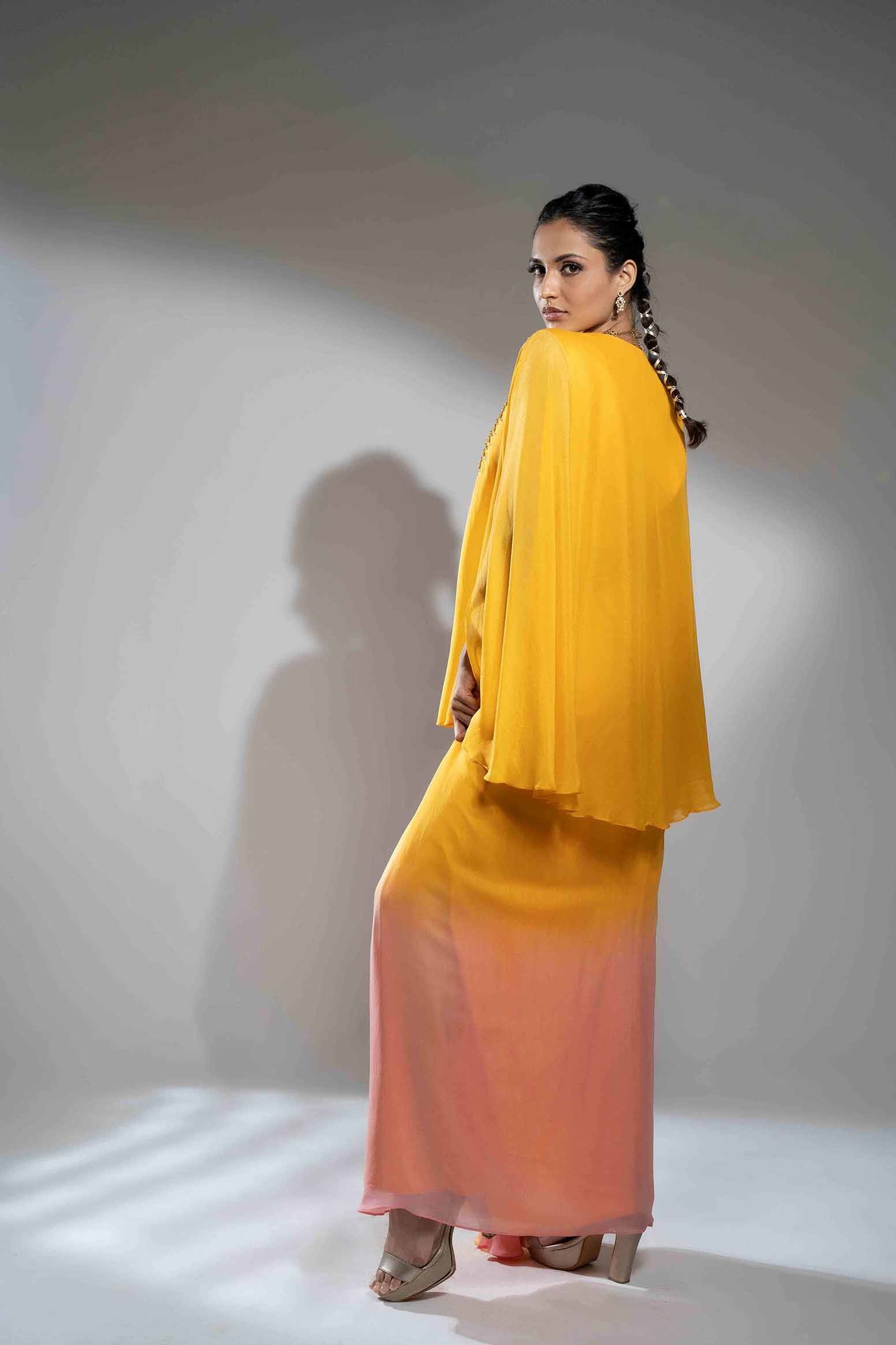 Mustard and pink cape style flowy poncho with draped skirt.
