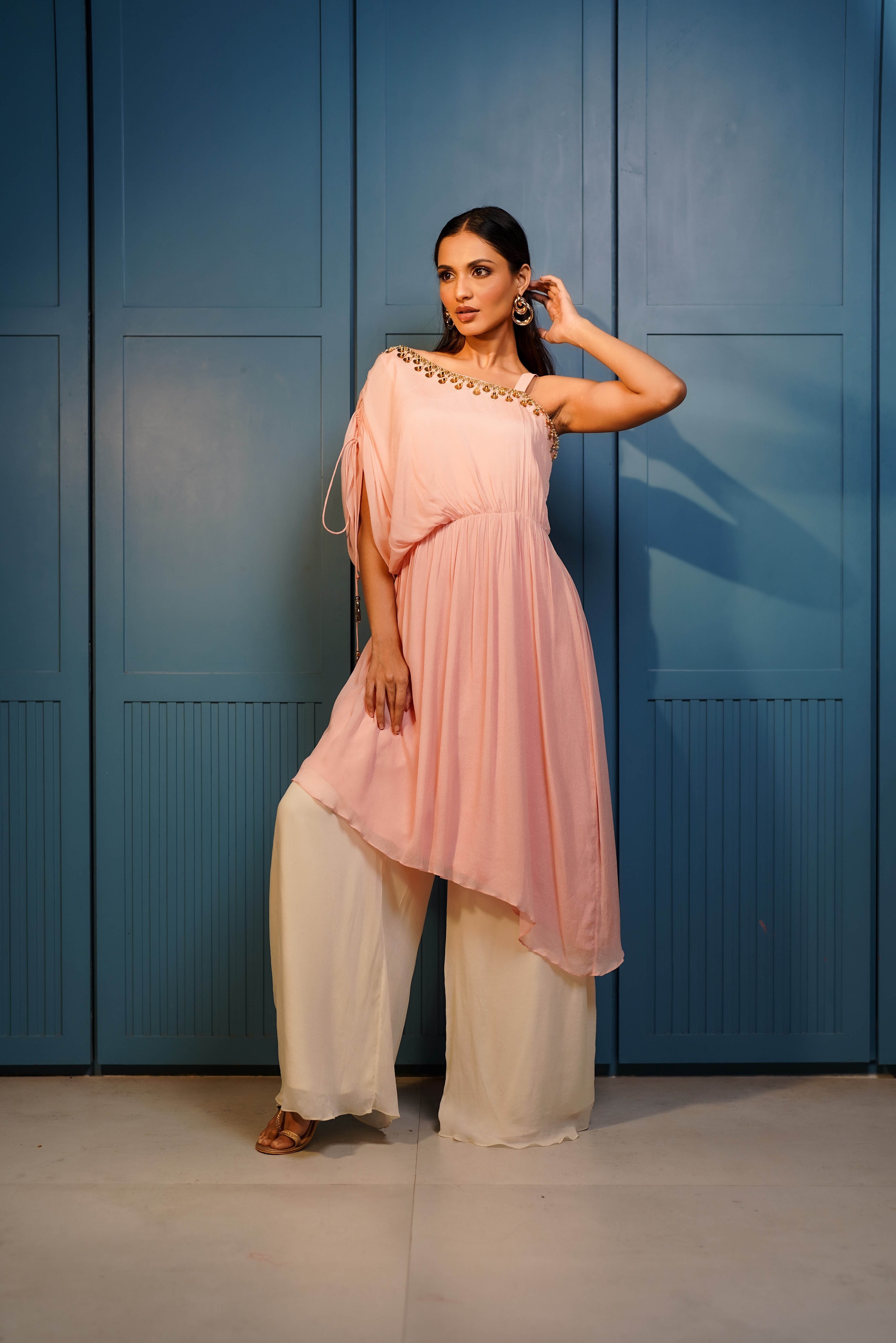 Baby pink one shoulder gathered tunic with flared palazzo.